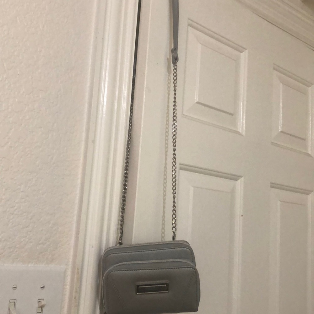 Small silver purse with chain strap.